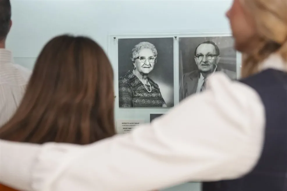 Two People Looking at Photos of Englers