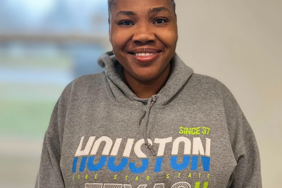 A Sunshine employee, Glorita, smiles for a photo.