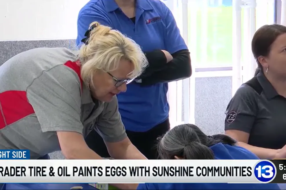 Employees from Shrader Tire & Oil participate in an inclusive egg painting activity with individuals supported by Sunshine Communities, as featured on 13abc’s Bright Side segment.