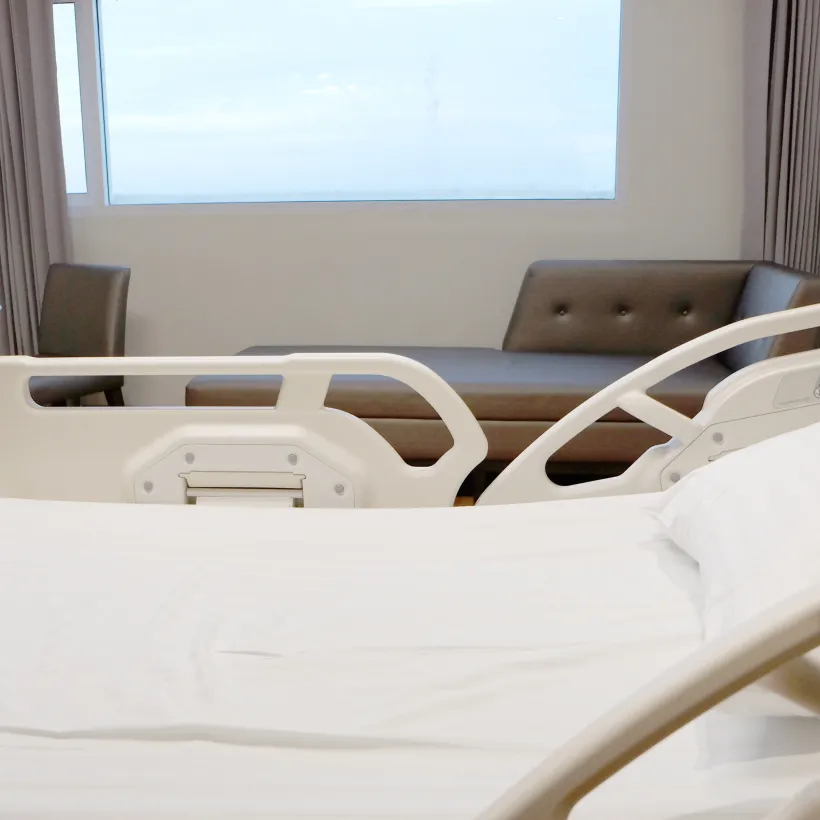 A White Bed with a Guard Rail