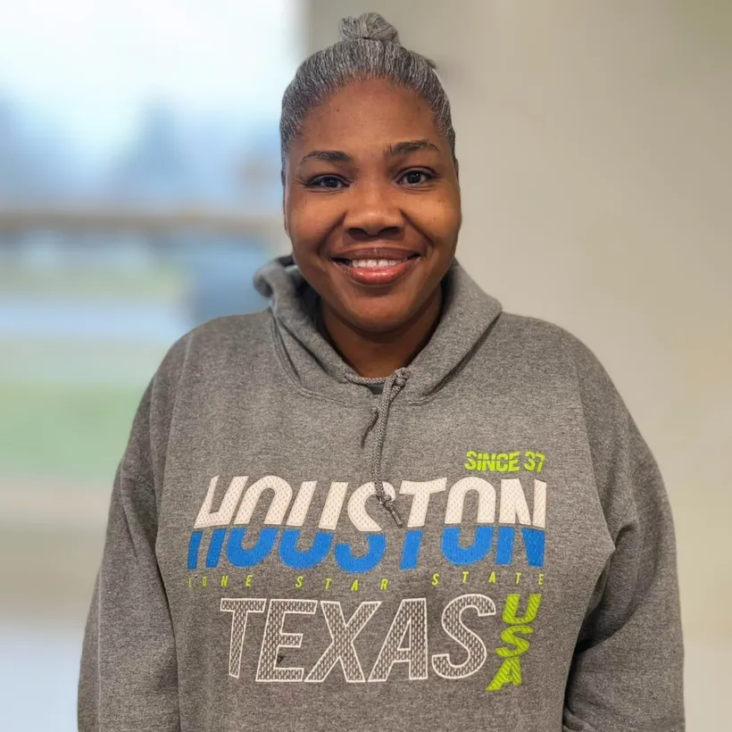 A Sunshine employee, Glorita, smiles for a photo.