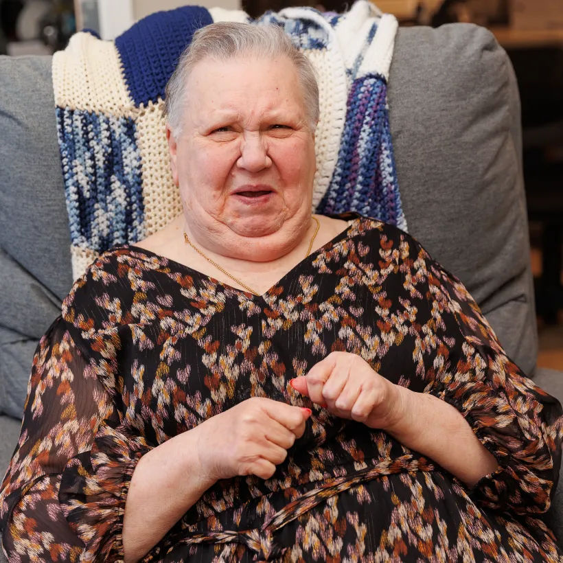 A Person in a Dress Sitting in a Grey Chair